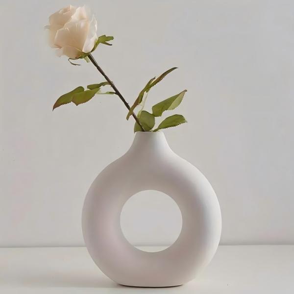 A round plastic vase is an artistic touch that suits your space. Add a touch of elegance and tranquility to your decor with this unique plastic vase.
