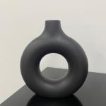 A round plastic vase is an artistic touch that suits your space. Add a touch of elegance and tranquility to your decor with this unique plastic vase.