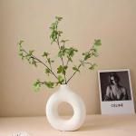 A round plastic vase is an artistic touch that suits your space. Add a touch of elegance and tranquility to your decor with this unique plastic vase.