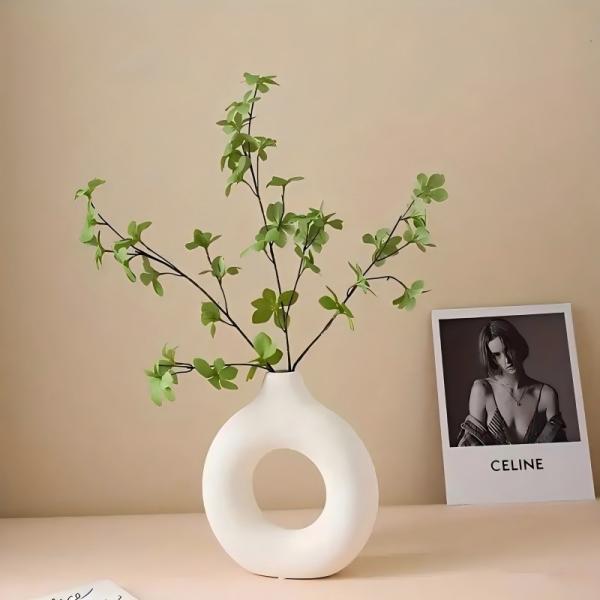 A round plastic vase is an artistic touch that suits your space. Add a touch of elegance and tranquility to your decor with this unique plastic vase.