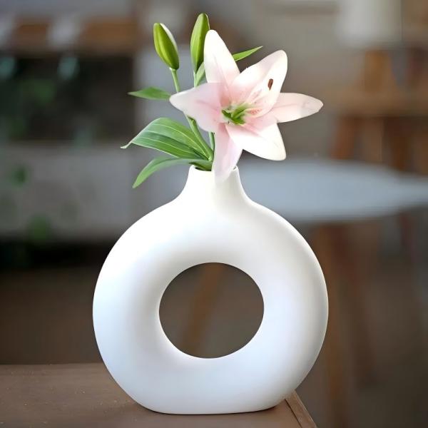 A round plastic vase is an artistic touch that suits your space. Add a touch of elegance and tranquility to your decor with this unique plastic vase.