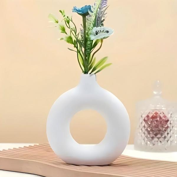 A round plastic vase is an artistic touch that suits your space. Add a touch of elegance and tranquility to your decor with this unique plastic vase.