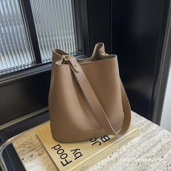 Bucket bags with a wallet are designed in a modern style that combines practicality and elegance. The bags feature a top drawstring design for easy closure.
