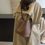 Bucket bags with a wallet are designed in a modern style that combines practicality and elegance. The bags feature a top drawstring design for easy closure.