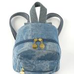 Small backpack and matching handbag in washed blue denim for a modern yet comfortable look.