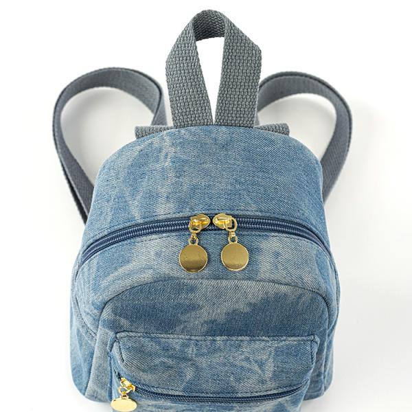 Small backpack and matching handbag in washed blue denim for a modern yet comfortable look.