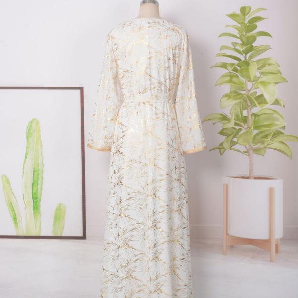 white dress embroidered with gold, a luxury that speaks of femininity