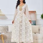 white dress embroidered with gold, a luxury that speaks of femininity