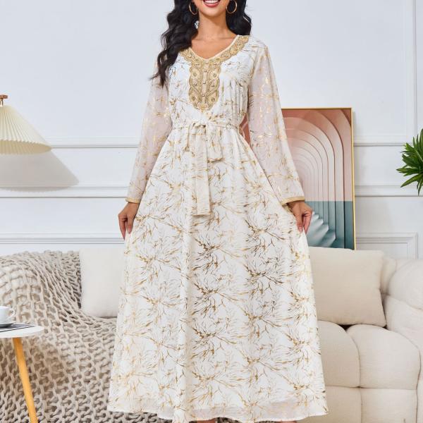 white dress embroidered with gold, a luxury that speaks of femininity