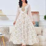 white dress embroidered with gold, a luxury that speaks of femininity