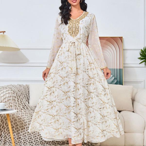 white dress embroidered with gold, a luxury that speaks of femininity