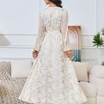 white dress embroidered with gold, a luxury that speaks of femininity