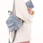 Small backpack and matching handbag in washed blue denim for a modern yet comfortable look.