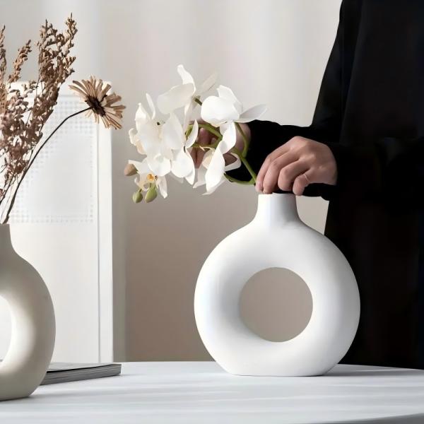 A round plastic vase is an artistic touch that suits your space. Add a touch of elegance and tranquility to your decor with this unique plastic vase.